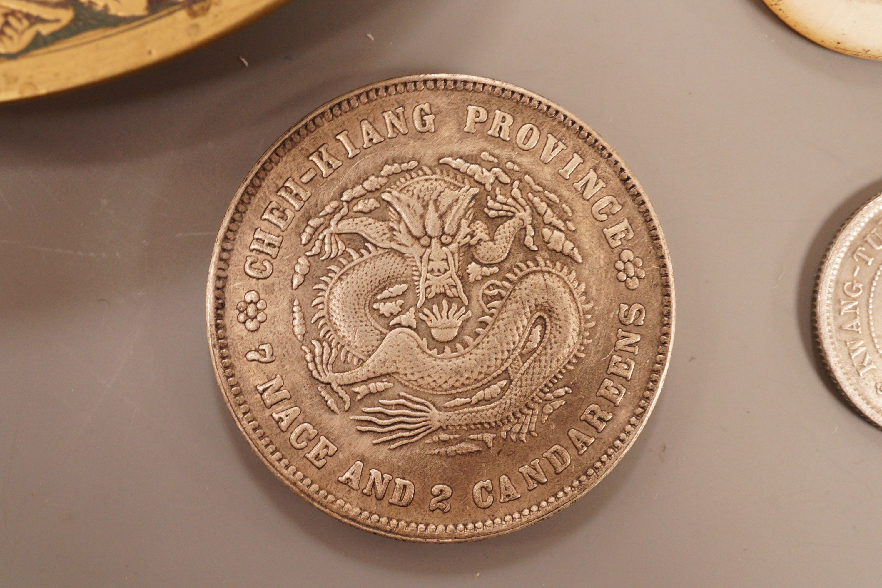 A brass tray, various coins and a rattle dish, 11.5cm diameter